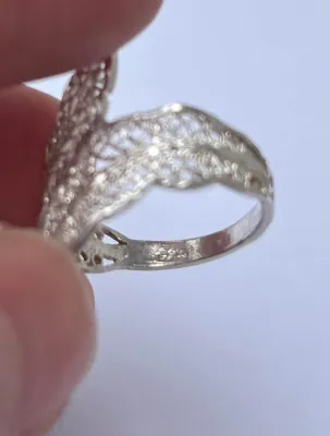 Sale Photo Thumbnail #201: Featuring a diamond cut filigree design, this 925 silver ring shows the popular image of the laurel wreath, which consists of interlocked leaves. Often associated with athletic and academic excellence, the laurel wreath symbolizes victory and greatness. A
