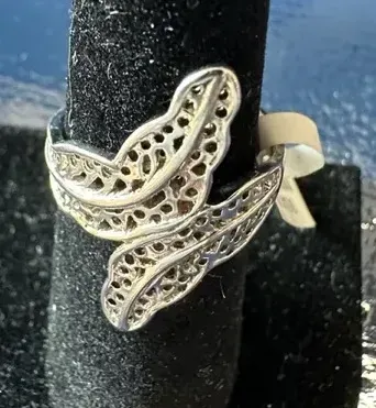 Sale Photo Thumbnail #200: Featuring a diamond cut filigree design, this 925 silver ring shows the popular image of the laurel wreath, which consists of interlocked leaves. Often associated with athletic and academic excellence, the laurel wreath symbolizes victory and greatness. A