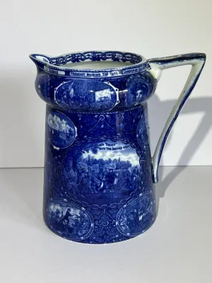Sale Photo Thumbnail #104: ROWLAND MARSELLUS HISTORICAL POTTERY PITCHER IN BLUE & WHITE WITH VIGNETTES OF VARIOUS HISTORICAL SCENES INCL WILLIAM PENNS TREATY, THE LANDING OF COLUMBUS, ETC. 7-1/2" TALL. $15 DOMESTIC SHIPPING.