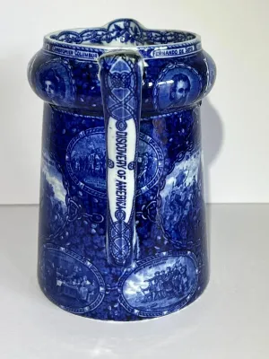 Sale Photo Thumbnail #105: ROWLAND MARSELLUS HISTORICAL POTTERY PITCHER IN BLUE & WHITE WITH VIGNETTES OF VARIOUS HISTORICAL SCENES INCL WILLIAM PENNS TREATY, THE LANDING OF COLUMBUS, ETC. 7-1/2" TALL. $15 DOMESTIC SHIPPING.