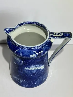 Sale Photo Thumbnail #106: ROWLAND MARSELLUS HISTORICAL POTTERY PITCHER IN BLUE & WHITE WITH VIGNETTES OF VARIOUS HISTORICAL SCENES INCL WILLIAM PENNS TREATY, THE LANDING OF COLUMBUS, ETC. 7-1/2" TALL. $15 DOMESTIC SHIPPING.