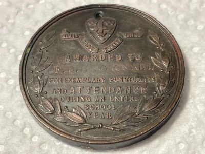 Sale Photo Thumbnail #446: Nottingham School Board Medal 1893 - Exemplary Punctuality Awarded to; F. HUCKNALL Bronze Composition as Pictured. (SILVER DOLLAR SIZED). $5 DOMESTIC SHIPPING.