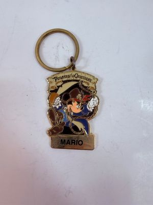 Sale Photo Thumbnail #289: Personalized Disneyland Resort Pirates of the Caribbean metal keychain featuring a pirate-themed Mickey Mouse dressed as Captain Jack Sparrow, with the name "MARIO" customized on the bottom tag.