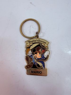Sale Photo Thumbnail #292: Personalized Disneyland Resort Pirates of the Caribbean metal keychain featuring a pirate-themed Mickey Mouse dressed as Captain Jack Sparrow, with the name "MARIO" customized on the bottom tag.