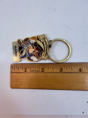 Sale Photo Thumbnail #290: Personalized Disneyland Resort Pirates of the Caribbean metal keychain featuring a pirate-themed Mickey Mouse dressed as Captain Jack Sparrow, with the name "MARIO" customized on the bottom tag.