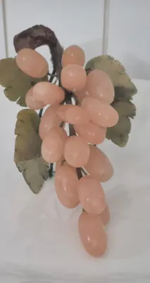 Sale Photo Thumbnail #22: This is a realistically carved rose jade bunch of grapes with darker jade carved leaves. The stem network is wire wrapped with blue satin cord and the end where it would have been cut from the vine is faux wood. The leaves and grapes have some flexibility