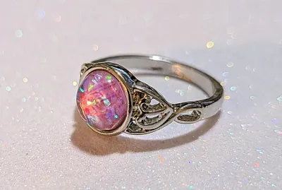 **NEW ARRIVAL** Size 7 Round PINK-ish (Changes Colors) IRIDESCENT STONE RING with a "Split Heart Band" on a Silver Tone Setting...