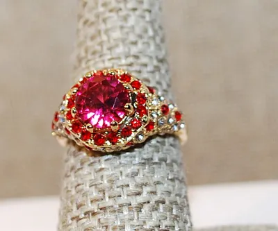 Size 7 Beautiful Bejeweled RED RING with Large Pink/Red Round Stone and Red & Clear Surround and Accent Stones on a Gold Tone Setting...