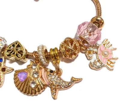 "SEASHORE EXTRAVGANZA" BRACELET with Pink Whale, Lobster, and Seashell; Jeweled Clam and Starfish; Rings of Pearls+Jewels; Gold...