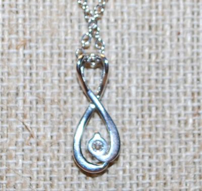 Figure "8" Symbol PENDANT (1" x ½") with a Single Clear Stone Accent on a Silver Tone Necklace Chain 18" L