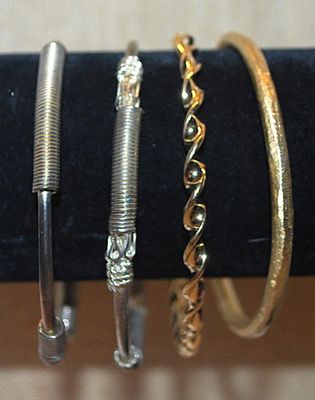 Collection of 4 BRACELETS (-2½"+ Opening) with Silver "Springs" and Brushed and Swirls Gold Tone Settings