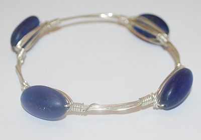 Silver Tone WIRED BRACELET (2¾" Opening) with 4 Long Oval Opaque BLUE Accents
