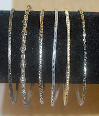 Collection of 6 BANGLE BRACELETS (2½" Opening) with an Assortment of Silver Tone Finishes & Graphics