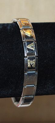 Silver Tone Elastic "LOVE' BRACELET (2¼" Opening) - Marked "ADD-A-CHARM ©" with Gold Colored Letters...