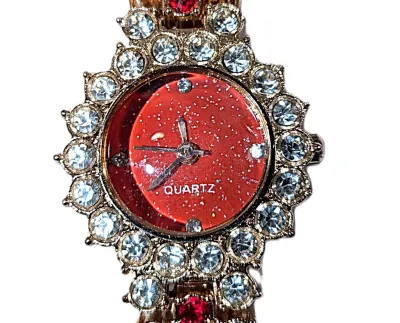 Sale Photo Thumbnail #312: GLITTERY RED JEWELED BAND & DIAL WATCH with BAND: (Gold Tone Red + Clear Stones Segments 7") DIAL: (¾" Jeweled Clear Stones Surround + Round) BATTERY: Button 20 mm  *EXTRA BATTERY INCL.*
ALL ITEMS SHIPPED FREE