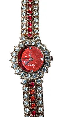 Sale Photo Thumbnail #311: GLITTERY RED JEWELED BAND & DIAL WATCH with BAND: (Gold Tone Red + Clear Stones Segments 7") DIAL: (¾" Jeweled Clear Stones Surround + Round) BATTERY: Button 20 mm  *EXTRA BATTERY INCL.*
ALL ITEMS SHIPPED FREE