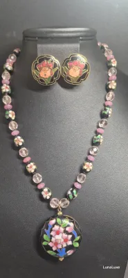 Sale Photo Thumbnail #440: The Cloisonne style pendant is large with a black background and pink flowers. The flowers appear on both sides of the pendant. The necklace is long with a chain that is interspersed with beads. The pendant is in perfect condition.
Cloisonne enameled earr