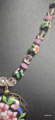 Sale Photo Thumbnail #438: The Cloisonne style pendant is large with a black background and pink flowers. The flowers appear on both sides of the pendant. The necklace is long with a chain that is interspersed with beads. The pendant is in perfect condition.
Cloisonne enameled earr