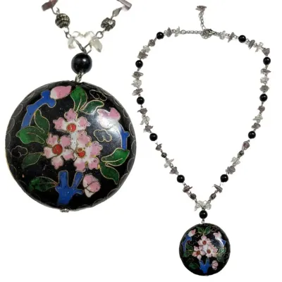 Sale Photo Thumbnail #441: The Cloisonne style pendant is large with a black background and pink flowers. The flowers appear on both sides of the pendant. The necklace is long with a chain that is interspersed with beads. The pendant is in perfect condition.
Cloisonne enameled earr