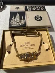 Vintage York cravat chain with personalized nameplate in its original presentation box, featuring a gold-tone chain and clip.