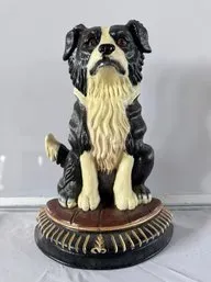Vintage painted cast iron doorstop depicting a sitting border collie on an ornate pedestal base.