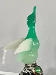 Vintage green and white slag glass duck bottle stopper, featuring a mallard-style duck with outstretched wings.