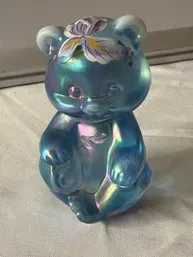Fenton iridescent blue glass bear figurine featuring a hand-painted floral design on its head.