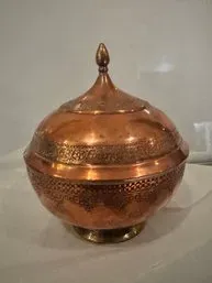 Vintage Middle Eastern hand-hammered copper lidded bowl featuring intricate chased floral and geometric patterns.