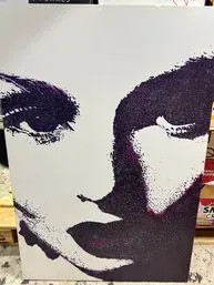 Contemporary canvas print featuring a high-contrast, stylized portrait of a woman's face in deep purple and white tones.