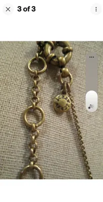 Sale Photo Thumbnail #94: A J. Crew statement necklace featuring a brass-tone chain and hardware. The design showcases geometric triangular elements in a deep burgundy/maroon hue, accented with clear rhinestones, a central marquise-cut stone, and dangling brass-tone spikes. Includ