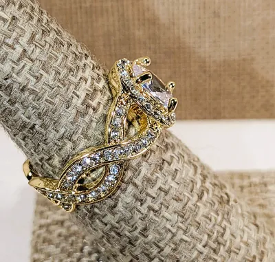 **New Arrival** Size 7¾ Ornate Bejeweled Clear Oval Main Stone RING with Side Loop Accents and Interesting Looped Gold Tone Setting &...