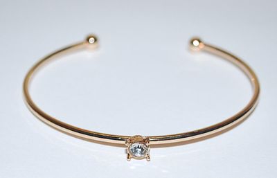 Single 4-Prong Round Clear Stone BRACELET (2½" Opening) on an OPEN-ENDED Gold Tone Setting