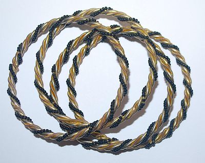 Collection of 4 Twisted IDENTICAL BRACELETS (2½" Opening) in Black, Gold & Silver Tones