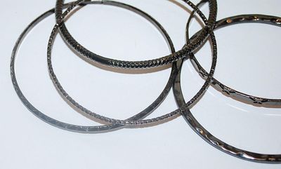 Collection of 5 Black BANGLE BRACELETS (2½" Opening) with Assorted Finishes