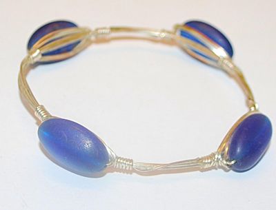 Silver Tone WIRED BRACELET (2¾" Opening) with 4 Long Oval Opaque BLUE Accents