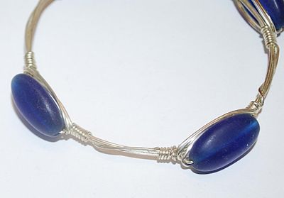 Silver Tone WIRED BRACELET (2¾" Opening) with 4 Long Oval Opaque BLUE Accents