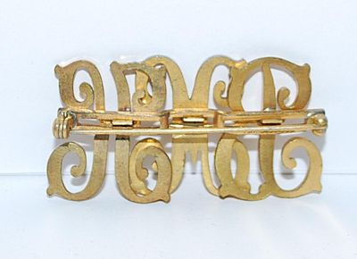 Gold Colored "BMK" BROOCH (2" x 1") on a Gold Tone Setting