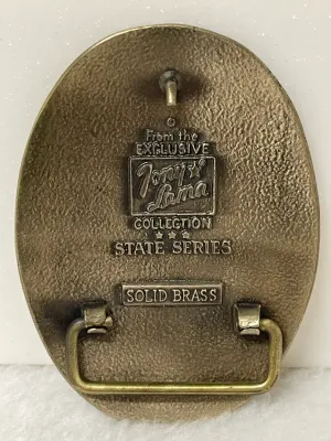 Sale Photo Thumbnail #156: Vintage Tony Lama Great Seal of the State of Oklahoma solid brass belt buckle from the State Series, featuring Oklahoma’s official state seal with the 1907 statehood date and detailed Western imagery throughout.