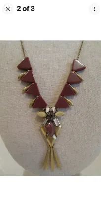 Sale Photo Thumbnail #265: A J. Crew statement necklace featuring a brass-tone chain and hardware. The design showcases geometric triangular elements in a deep burgundy/maroon hue, accented with clear rhinestones, a central marquise-cut stone, and dangling brass-tone spikes. Includ