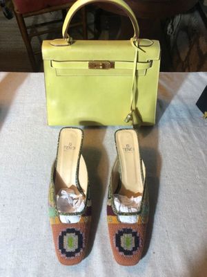 REINA made in Italy green leather top-handle Kelly handbag with gold-tone hardware, paired with FENDI  beaded mules featuring a colorful...