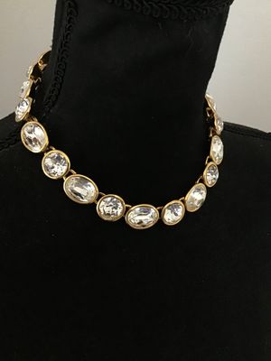 Sale Photo Thumbnail #6: A vintage gold-tone collar necklace by Napier featuring bezel-set round and oval faceted clear crystals/rhinestones. Secured with a fold-over clasp stamped NAPIER. In good condition with bright stones and minor surface wear typical of age. See photos with
