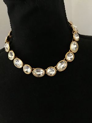 Sale Photo Thumbnail #5: A vintage gold-tone collar necklace by Napier featuring bezel-set round and oval faceted clear crystals/rhinestones. Secured with a fold-over clasp stamped NAPIER. In good condition with bright stones and minor surface wear typical of age. See photos with