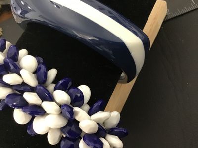 Sale Photo Thumbnail #9: Set of two vintage navy blue and white costume jewelry bracelets. Includes one chunky resin/plastic striped bangle bracelet and one cluster beaded stretch bracelet featuring faceted navy blue and smooth white teardrop-shaped beads. Both items are in good 