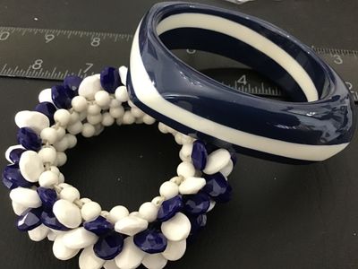 Sale Photo Thumbnail #7: Set of two vintage navy blue and white costume jewelry bracelets. Includes one chunky resin/plastic striped bangle bracelet and one cluster beaded stretch bracelet featuring faceted navy blue and smooth white teardrop-shaped beads. Both items are in good 