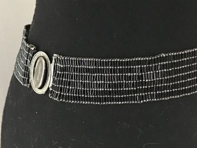 Sale Photo Thumbnail #15: Vintage wide beaded belt featuring black bugle beads and silver-tone seed beads arranged in a textured grid pattern. Features an oval silver-tone slide or hook buckle. Good vintage condition with light wear consistent with age.