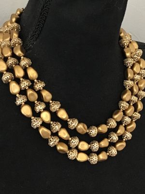 Sale Photo Thumbnail #24: A vintage mid-century style multi-strand necklace featuring three layers of matte gold-tone nugget-shaped beads alternating with intricate openwork filigree metal spacer beads. Includes an adjustable hook-and-tail clasp with gold-tone bead extender. Good 