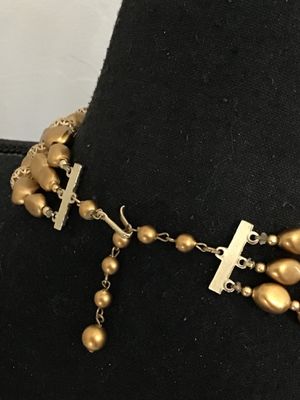 Sale Photo Thumbnail #26: A vintage mid-century style multi-strand necklace featuring three layers of matte gold-tone nugget-shaped beads alternating with intricate openwork filigree metal spacer beads. Includes an adjustable hook-and-tail clasp with gold-tone bead extender. Good 