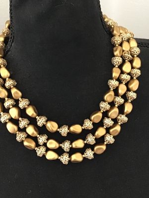 Sale Photo Thumbnail #25: A vintage mid-century style multi-strand necklace featuring three layers of matte gold-tone nugget-shaped beads alternating with intricate openwork filigree metal spacer beads. Includes an adjustable hook-and-tail clasp with gold-tone bead extender. Good 