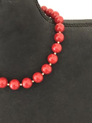 Sale Photo Thumbnail #28: A classic strand necklace featuring vibrant glossy red round beads separated by small gold-tone spacer beads. Features a traditional gold-tone hook and end bead clasp closure. Appears to be in good vintage condition with minimal surface wear. Please revie