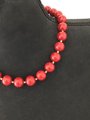 Sale Photo Thumbnail #30: A classic strand necklace featuring vibrant glossy red round beads separated by small gold-tone spacer beads. Features a traditional gold-tone hook and end bead clasp closure. Appears to be in good vintage condition with minimal surface wear. Please revie